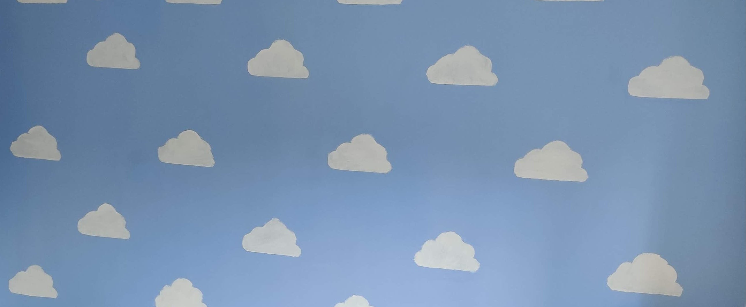 Blue wall with white cloud patterns